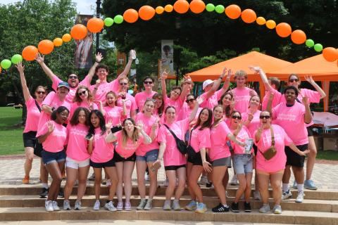 Event staff team photo in pink shirts
